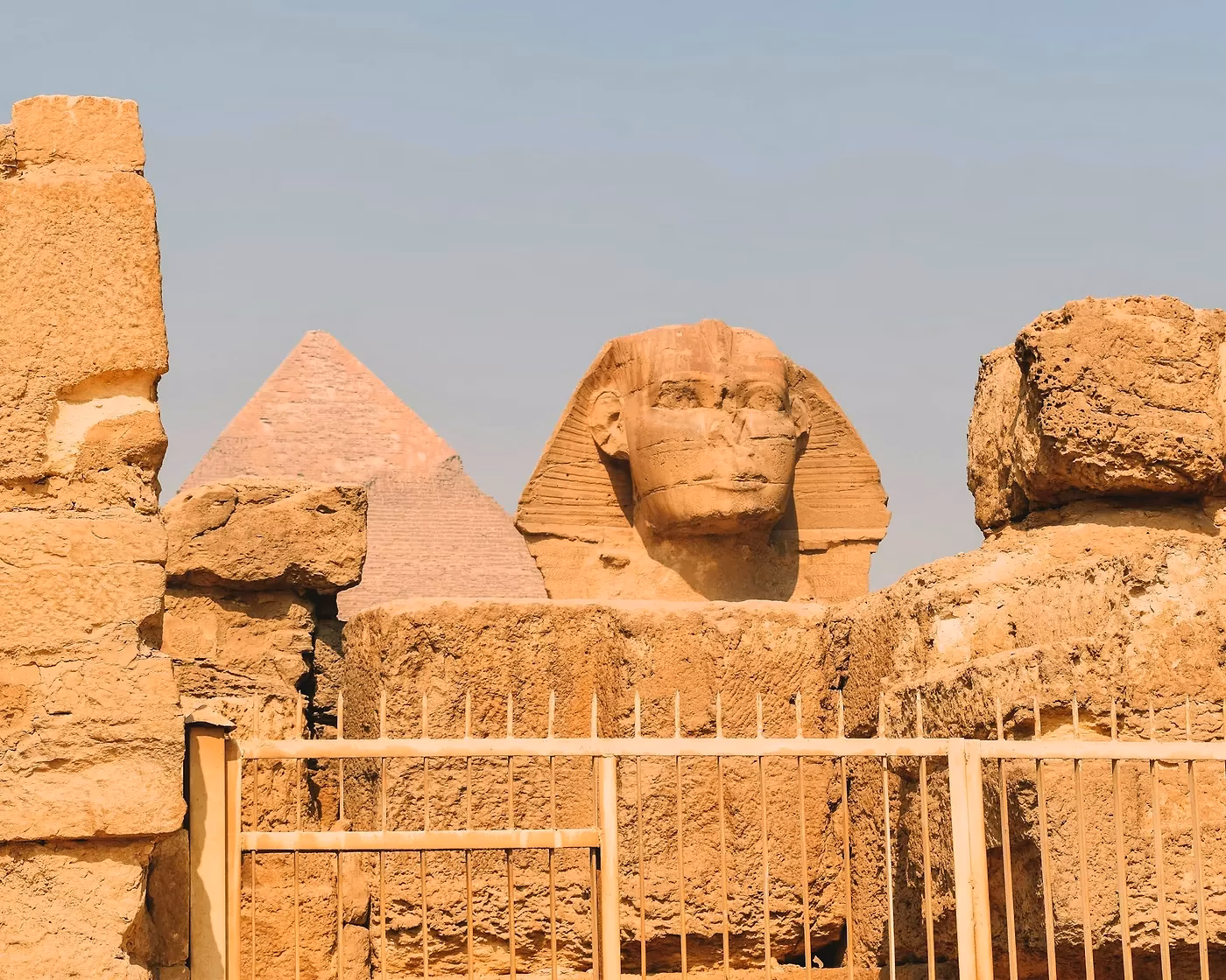 Een Sfinx en een piramide achter een hek